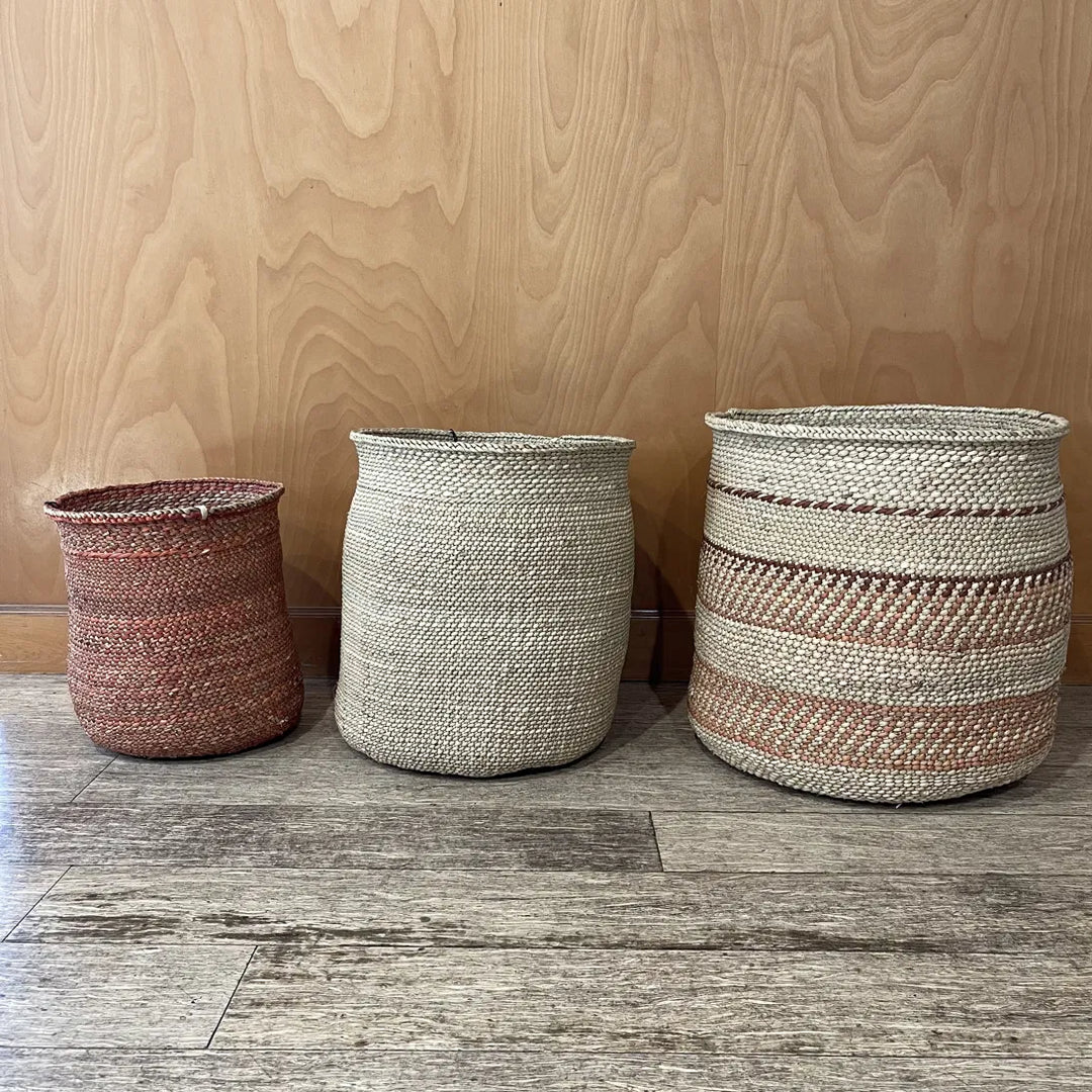 A terracotta Auburn medium, natural large and Auburn Stripe extra large basket lined up as a mixed set