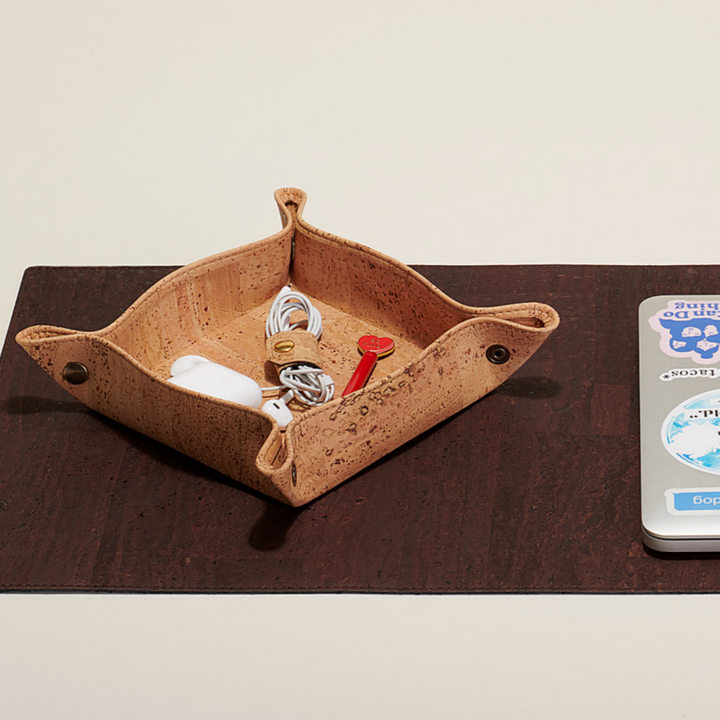 Cork catch-all tray for organizing small items on a desk or countertop.