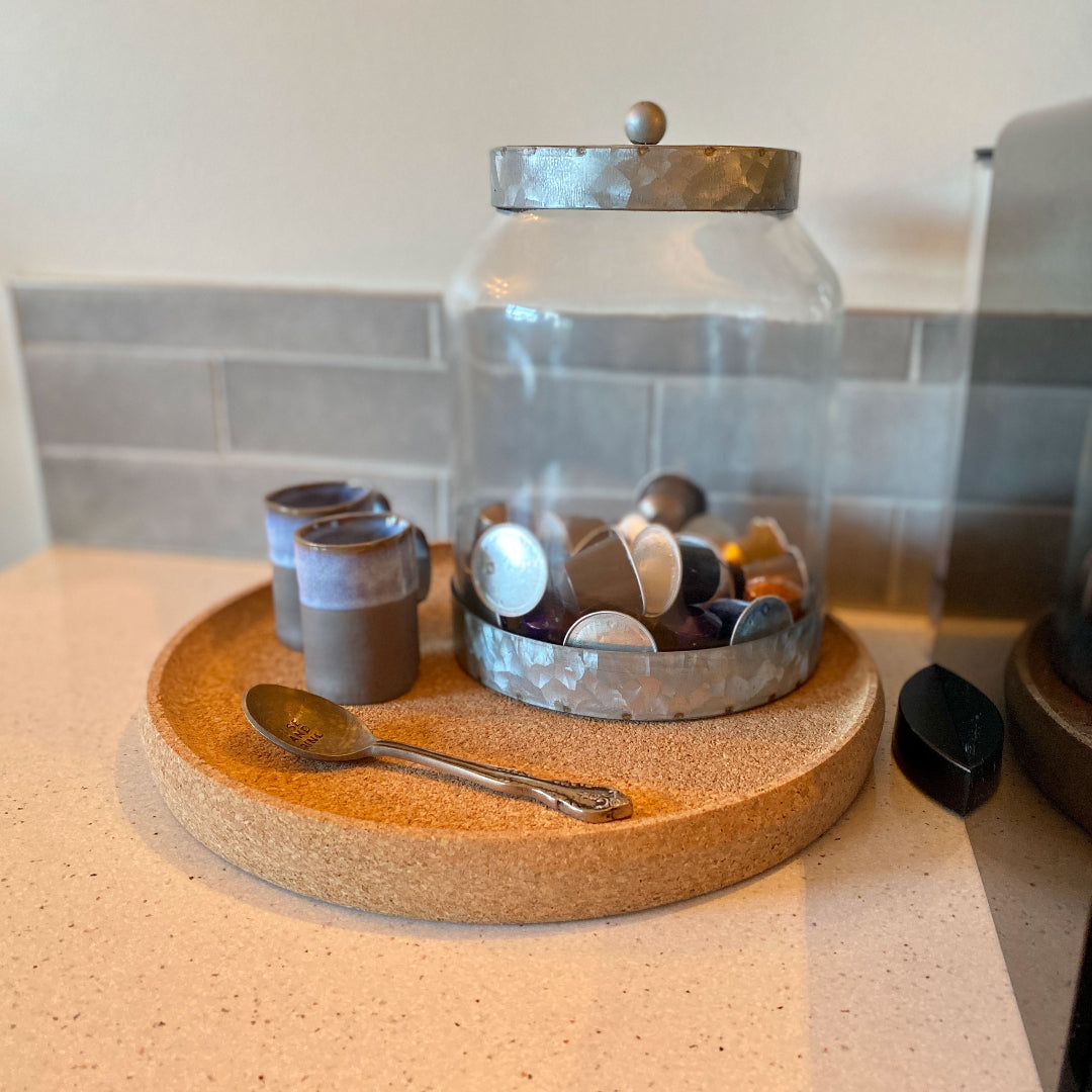 Round minimalist cork tray with smooth edges and a natural cork surface.