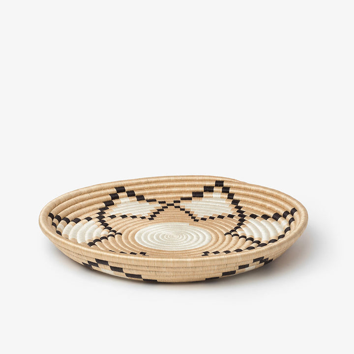 Neri natural sisal woven tray with side handles and a stepped sunburst pattern in black and natural.