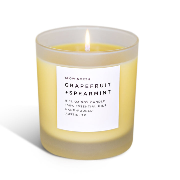 Grapefruit Spearmint signature candle in a sleek glass container with citrus and mint notes.