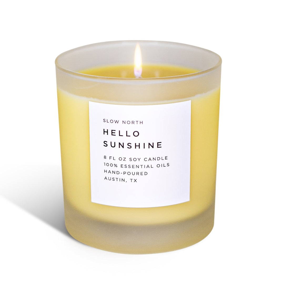 Hello Sunshine signature candle in a glass jar with citrus blend scent.