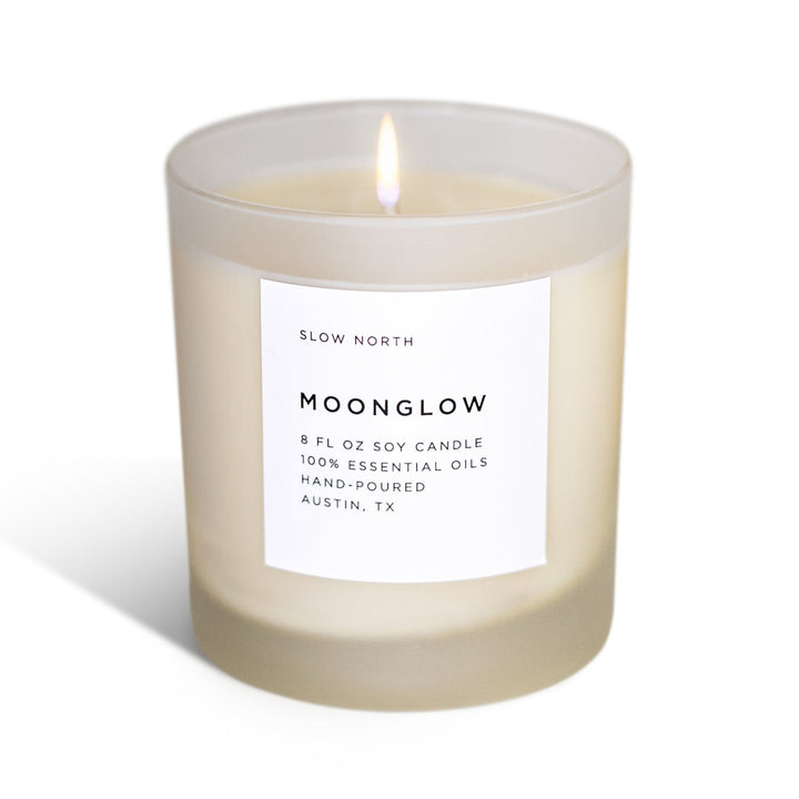 Moonglow signature candle with patchouli and cinnamon scent in a minimalist candle jar.