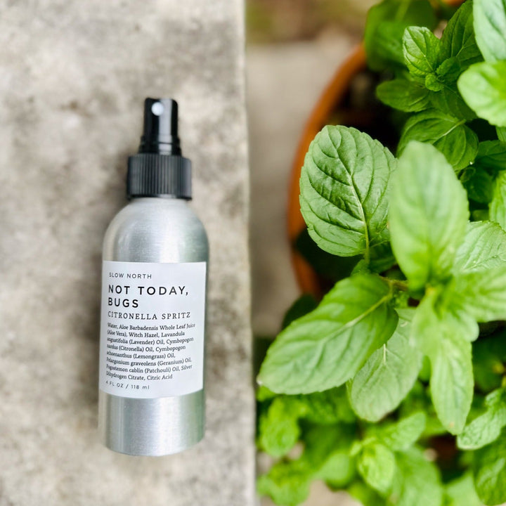 Bug spray bottle with lavender, citronella, lemongrass, geranium, and patchouli essential oils.