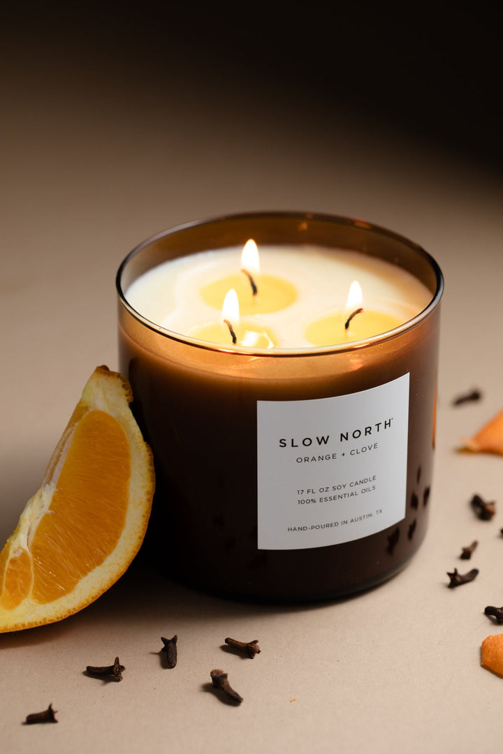 Orange Clove three-wick candle with orange and clove soy wax and three cotton wicks.