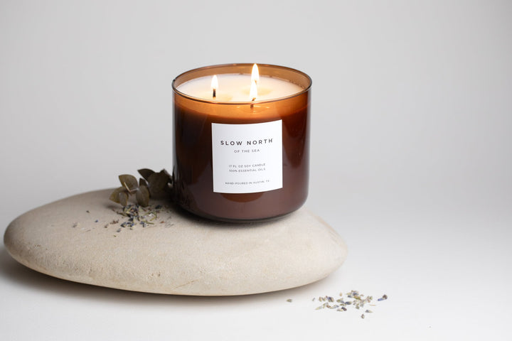 Of The Sea three-wick candle in a decorative glass jar.
