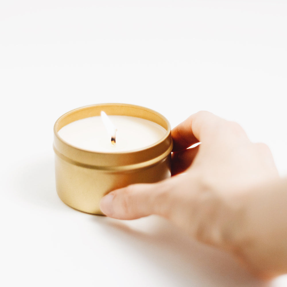 Of The Sea soy candle in a brushed gold tin with a minimalist design.