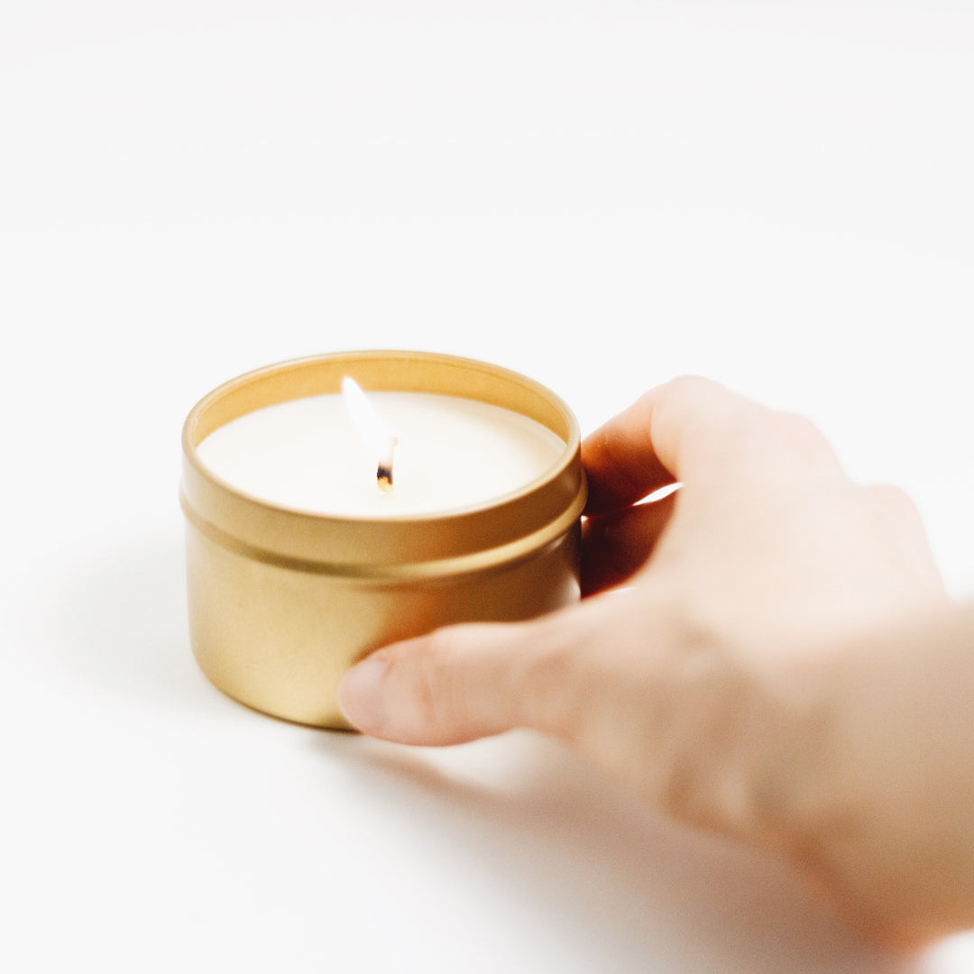 Of The Sea soy candle in a brushed gold tin with a minimalist design.