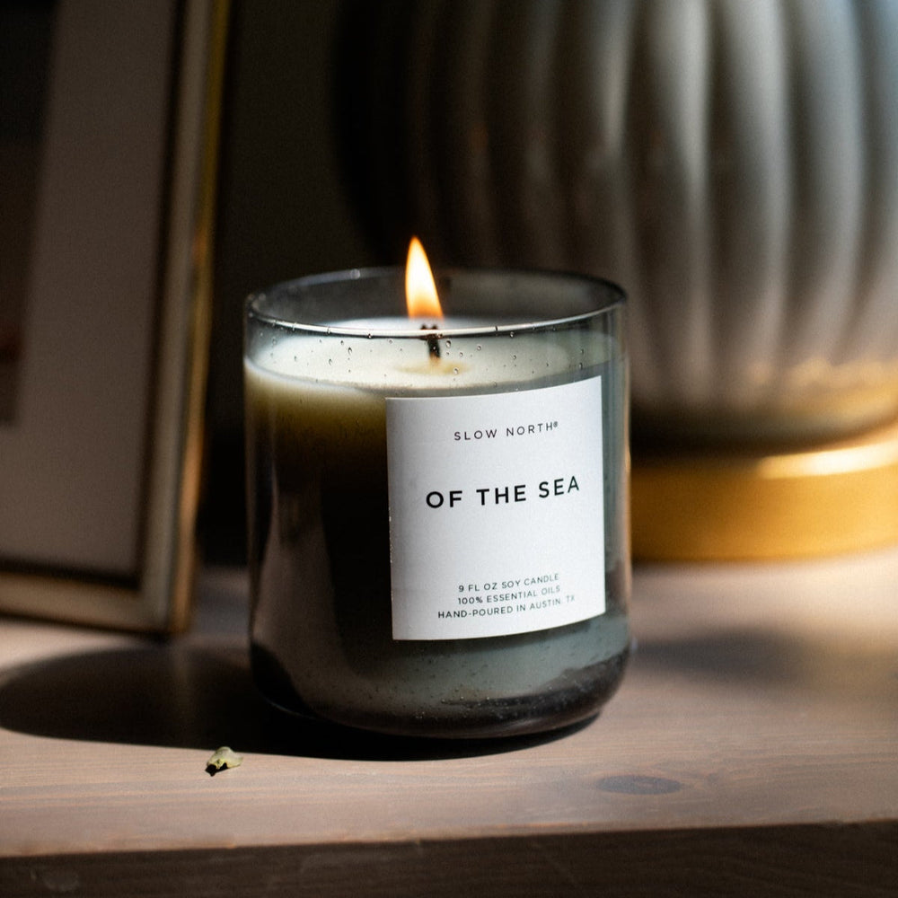Of The Sea Spa Collection candle in a smokey grey bubble glass vessel with a soothing herbal scent.