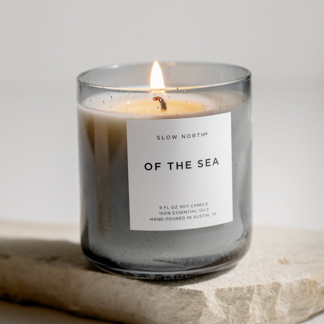 Of The Sea Spa Collection candle with eucalyptus, lavender, and peppermint in a smokey grey bubble glass vessel.