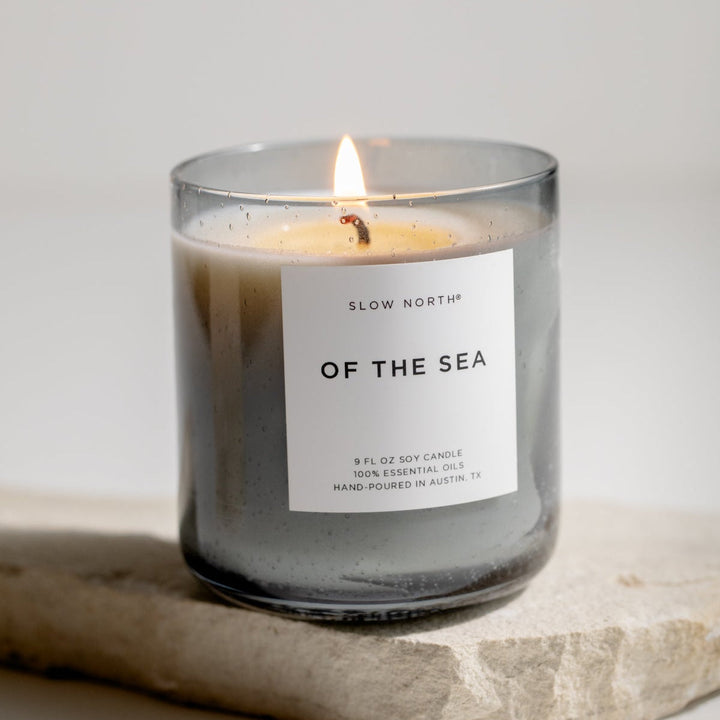 Of The Sea Spa Collection candle with eucalyptus, lavender, and peppermint in a smokey grey bubble glass vessel.