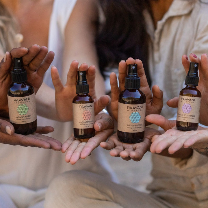 Ayurvedic aromatherapy ritual kit with essential oils and accessories on a wooden tray.