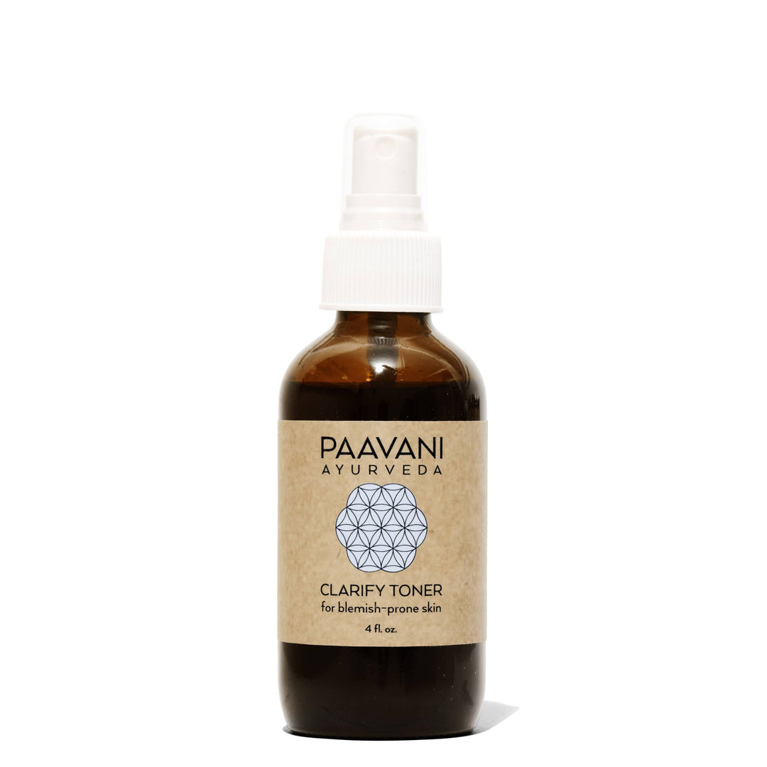 Clarify face toner with neem and rose in a clear bottle with a flip-top cap.