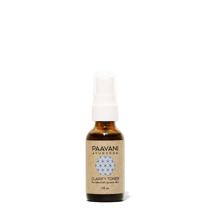 Clarify face toner with neem and rose in a clear bottle with floral and herbal ingredients.