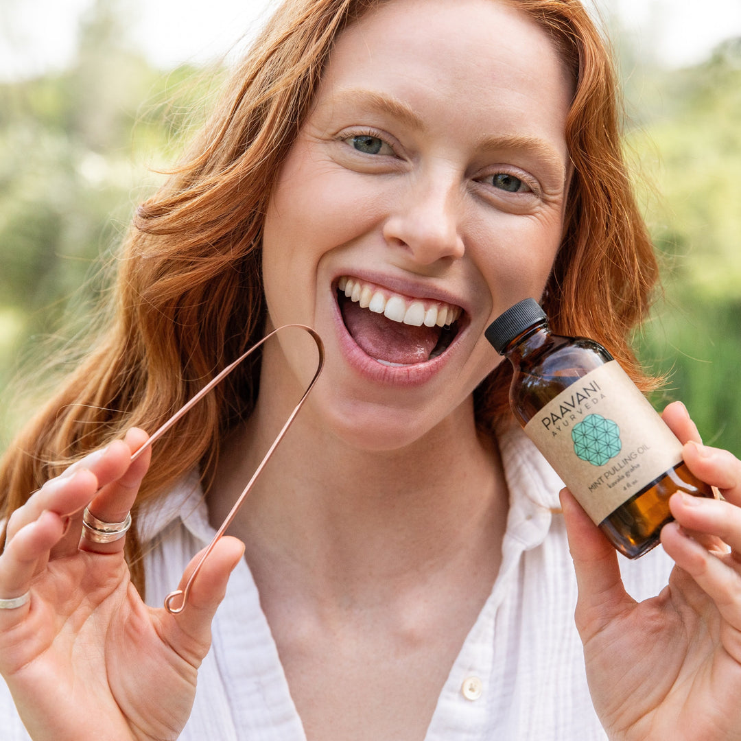 Ayurvedic oral care kit with tongue scraper and herbal pulling oil for the morning routine.