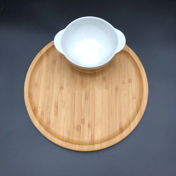 Single-serve porcelain bowl with a smooth, natural finish, on a bamboo tray.