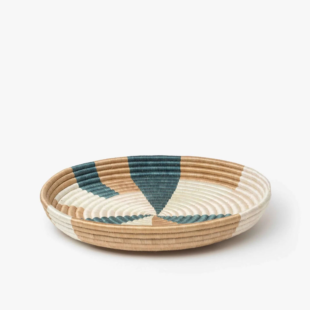 Prism woven bowls in teal and light pink sisal with a colorful pinwheel pattern.