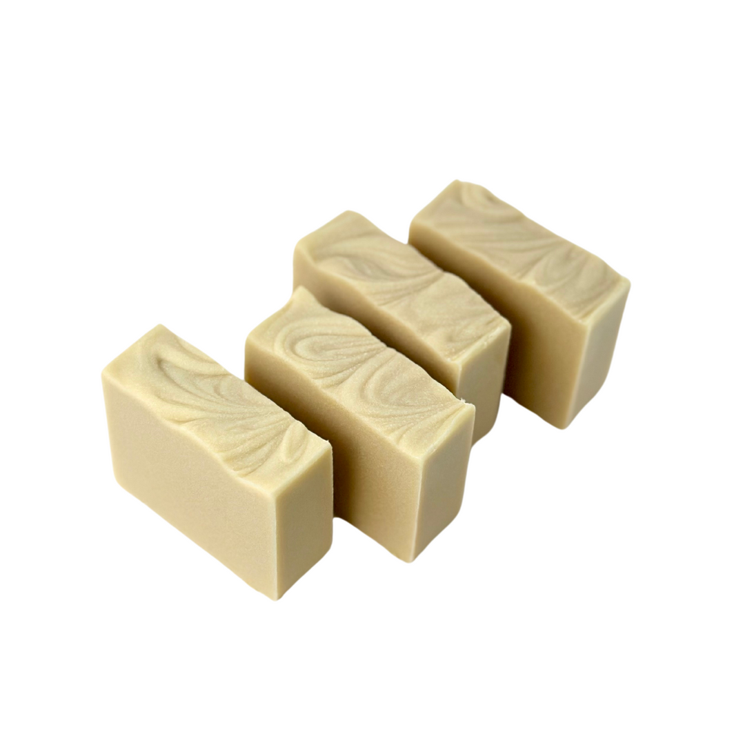 Package-free natural soap collection with four different bars and minimal kraft labeling.
