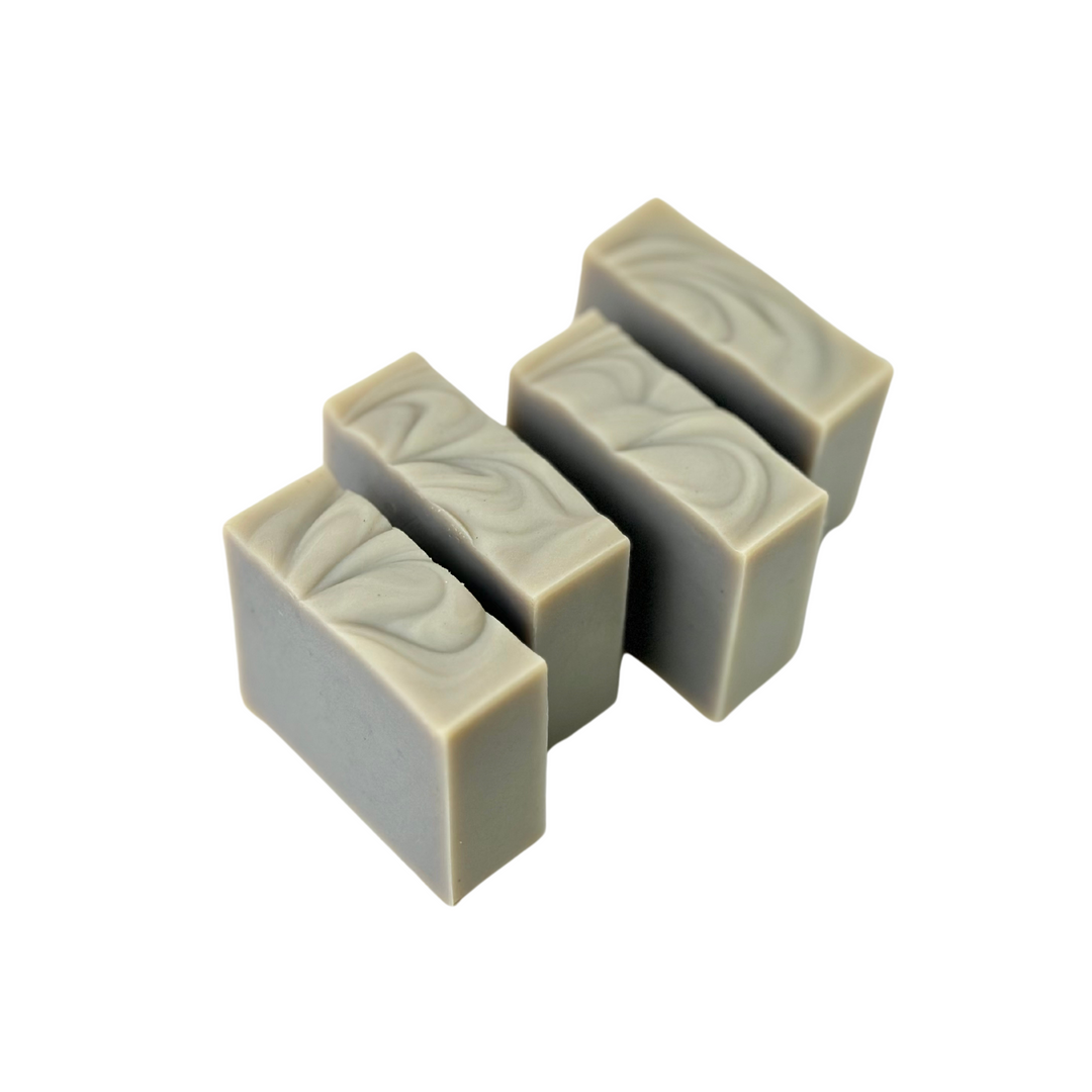 Set of four rustic soap bars with handcrafted finishes.