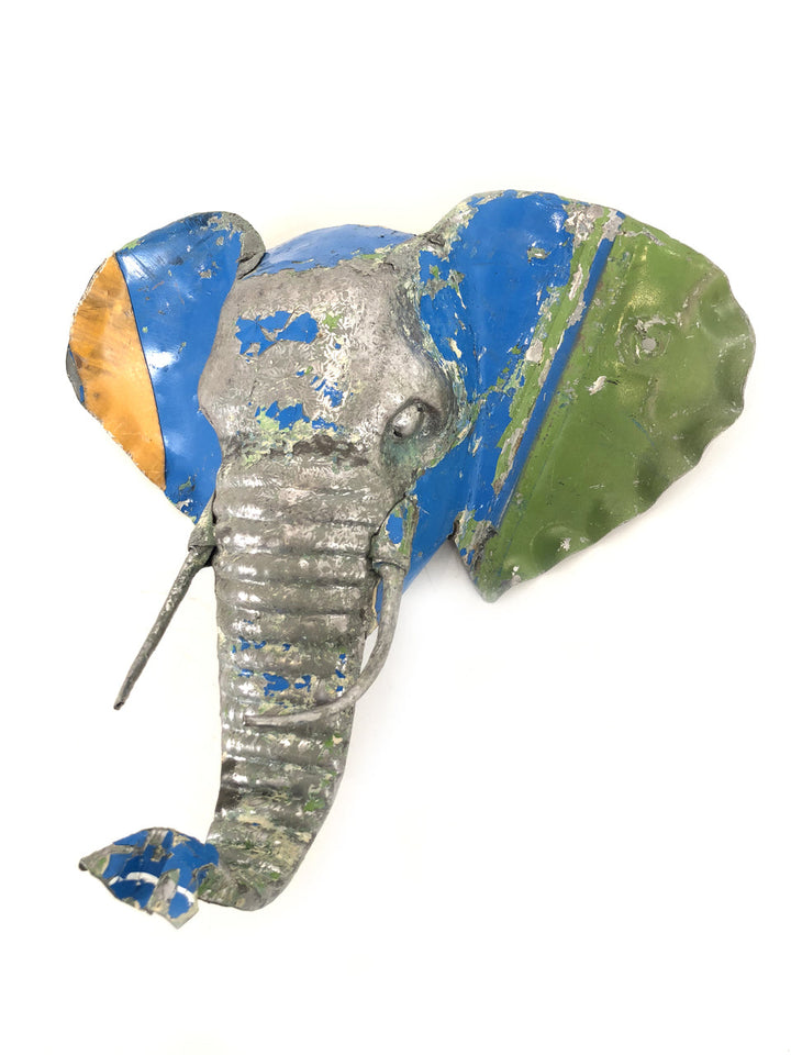 Recycled metal elephant mask with intricate, textured hand-formed details.