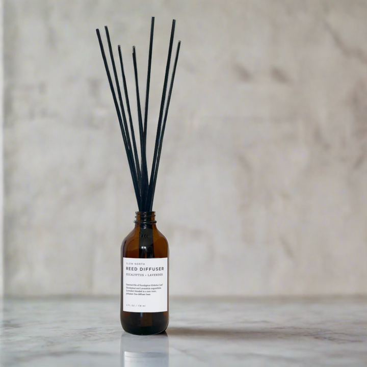 Reed diffuser with eucalyptus and lavender essential oils in glass packaging.