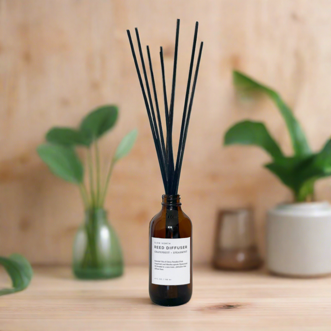 Citrus and mint reed diffuser shown with sleek glass packaging.