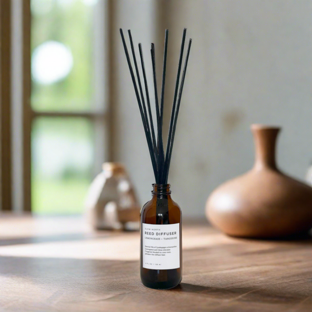 Citrus and grass scented reed diffuser with bamboo-style reed sticks.