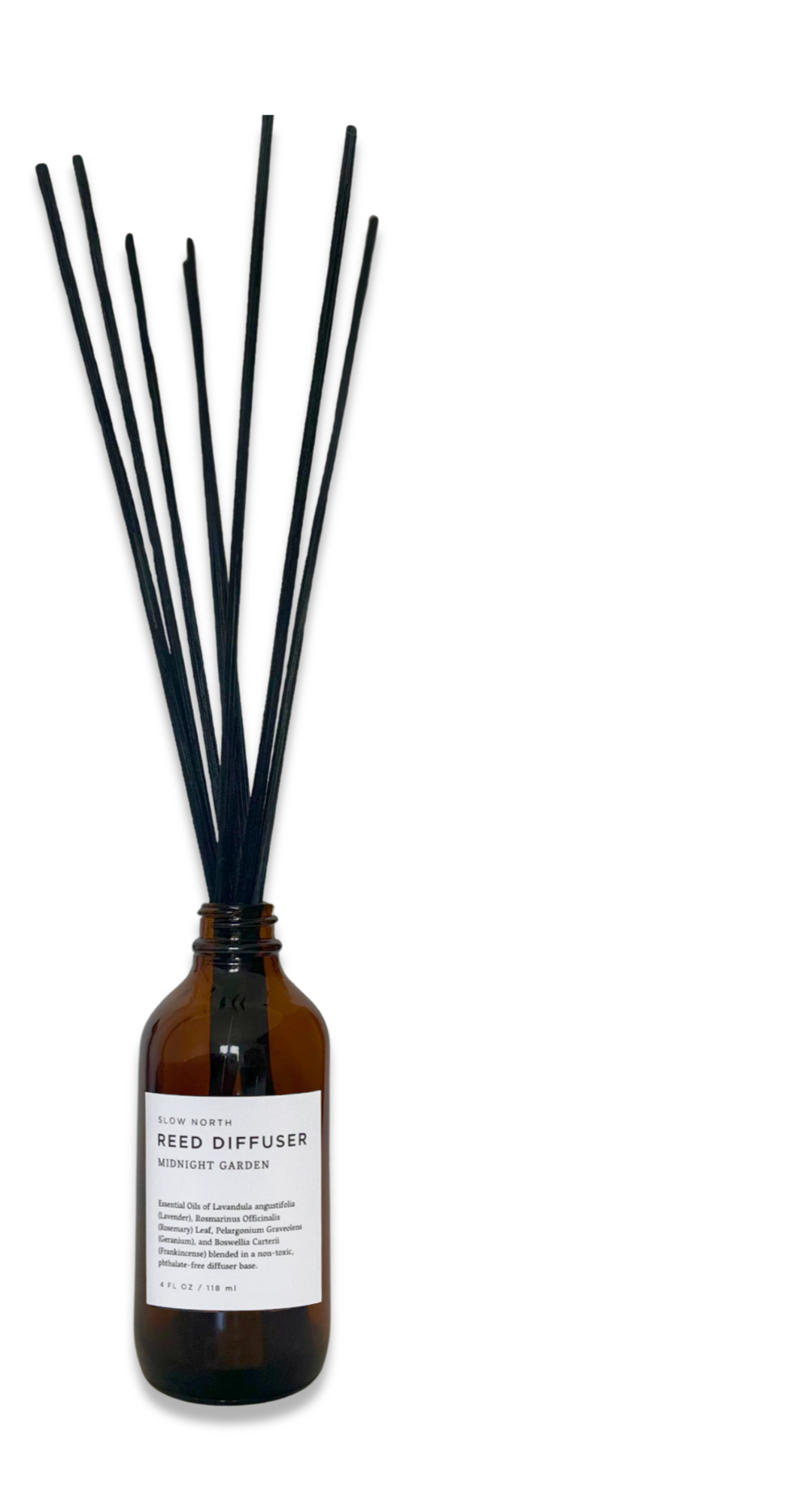 Midnight Garden reed diffuser with clear glass bottle and natural rattan reed sticks.