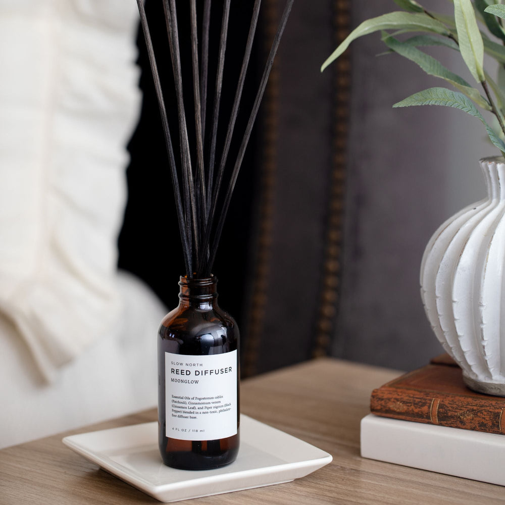 Reed diffuser with warm spice scent profile and elegant glass packaging.