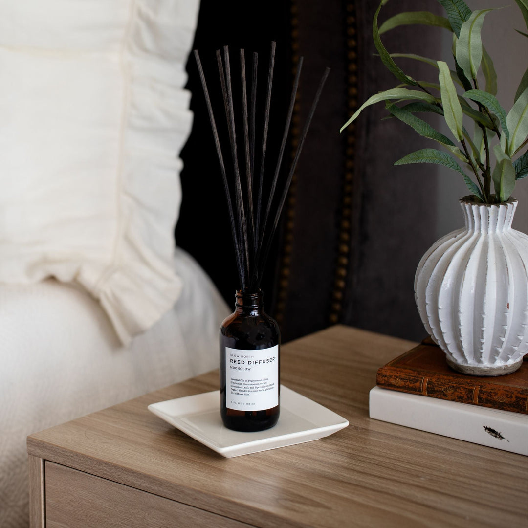 Moonglow reed diffuser with patchouli cinnamon blend in clear glass packaging.