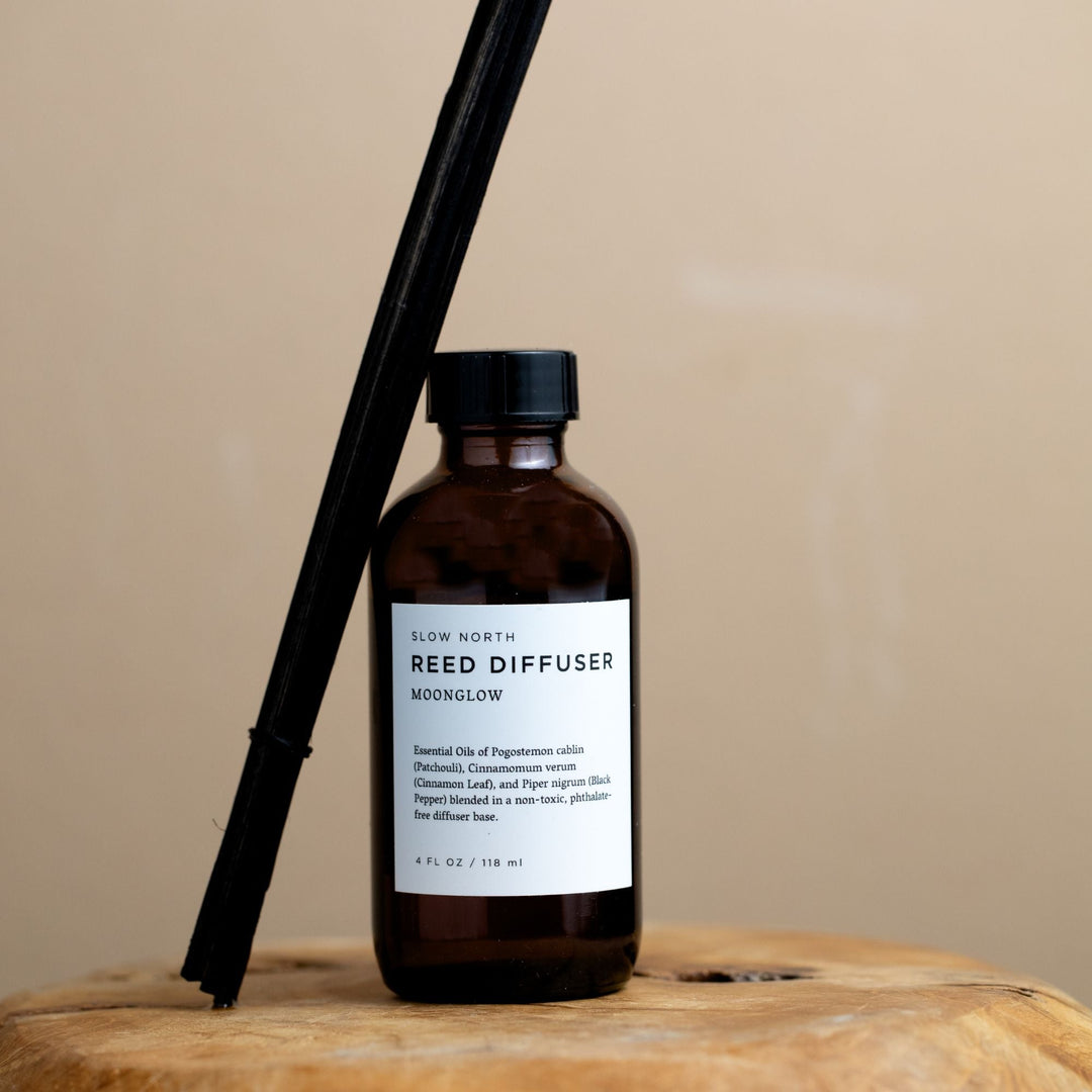 Patchouli and cinnamon reed diffuser shown with rattan reed sticks.