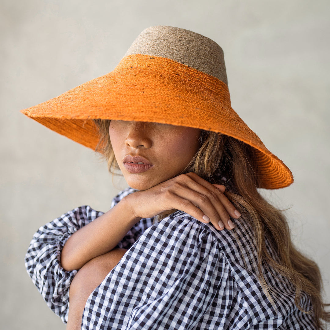 Duo jute straw hat in vibrant tangerine orange, featuring a wide brim and stylish design for sun coverage.