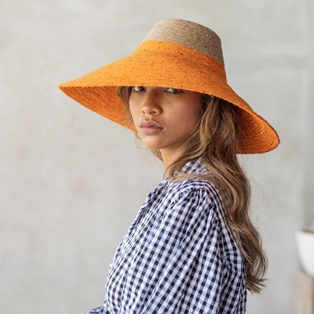 Duo jute straw hat in tangerine orange with a wide brim, for sun coverage and stylish summer wear.