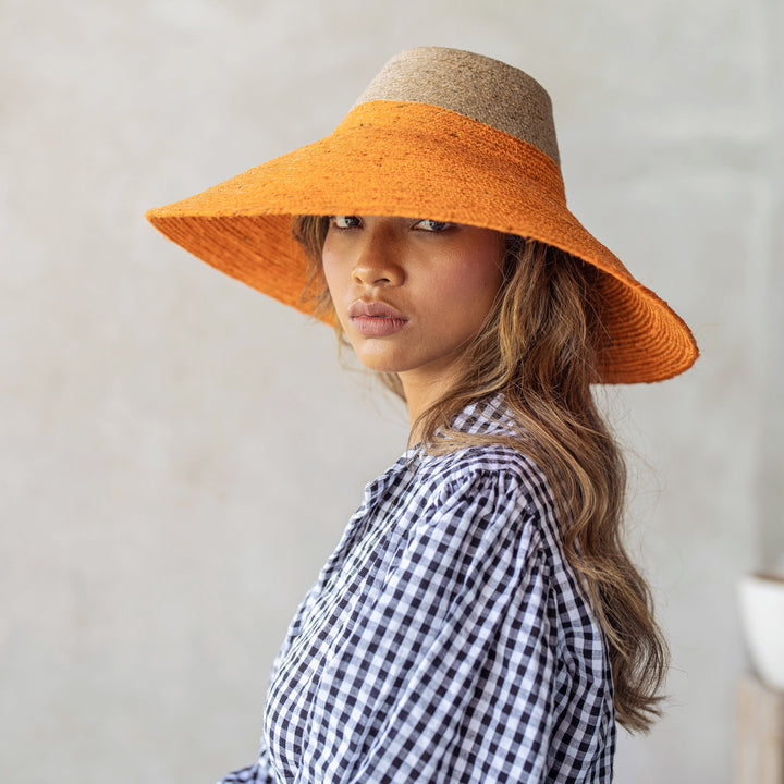 Duo jute straw hat in tangerine orange with a wide brim, for sun coverage and stylish summer wear.