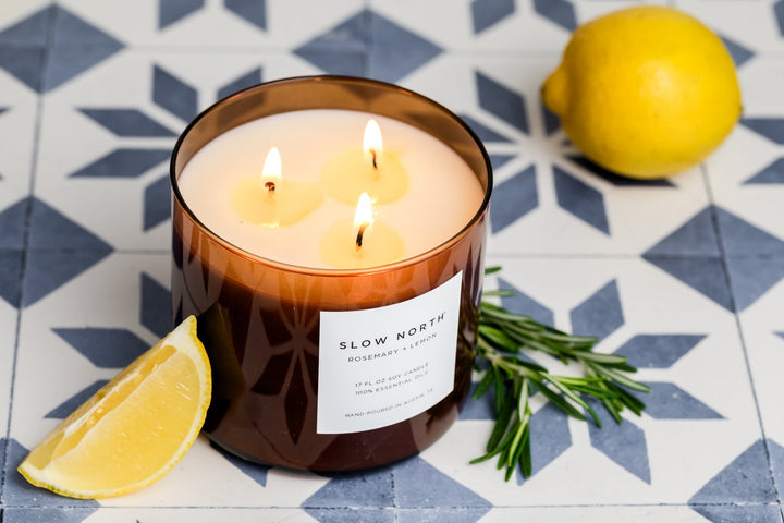 Rosemary Lemon three-wick candle in a glass jar with fresh herb and citrus scent.