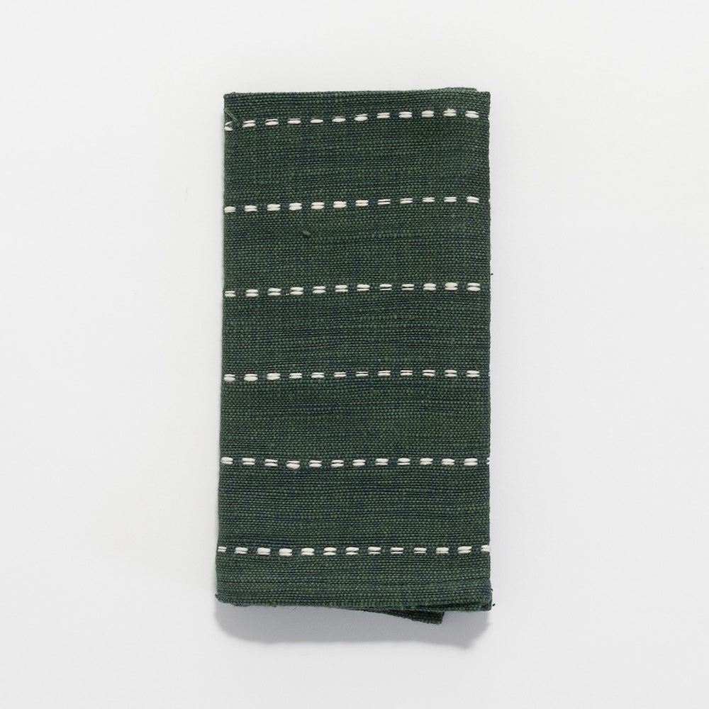 Cedar green handwoven Ethiopian cotton cocktail napkin with fine white lines, folded, on a white background