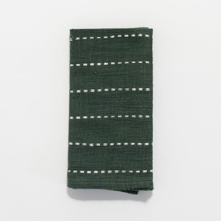 Cedar green handwoven Ethiopian cotton cocktail napkin with fine white lines, folded, on a white background