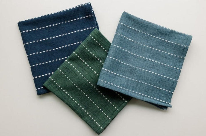 Navy, cedar and steel blue cocktail napkins laid together