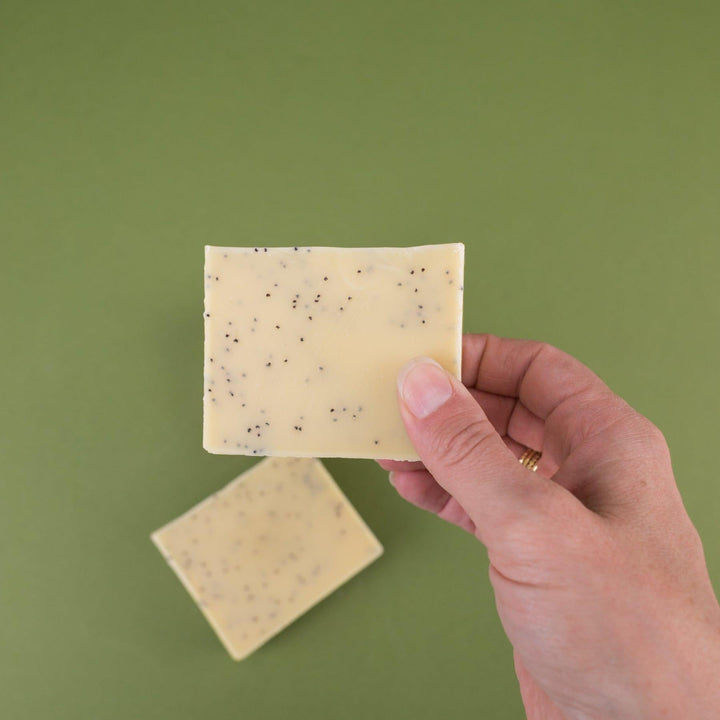 Natural bar soap photographed with rosemary and lemon as styling elements.