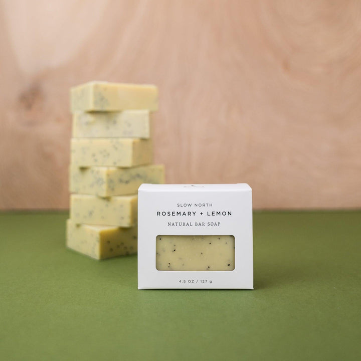 Cold-process bar soap with textured surface and visible rosemary lemon detail.