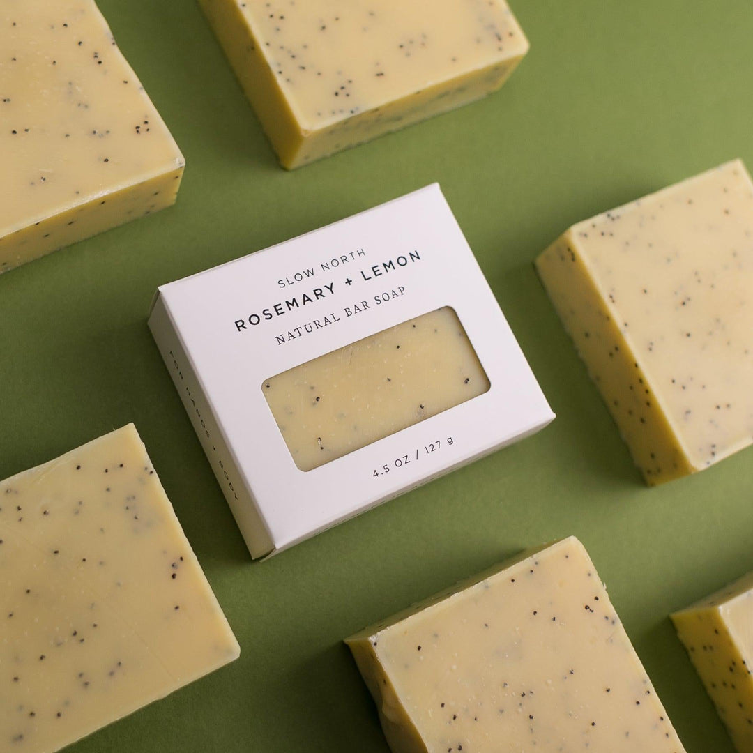 Rosemary lemon soap bar in branded kraft paper packaging.