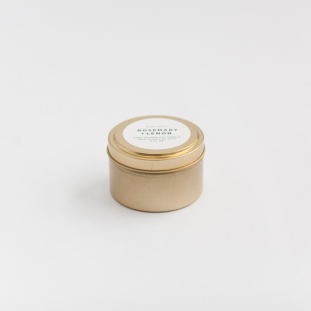 Rosemary lemon travel tin candle with fresh herbs and citrus aroma.
