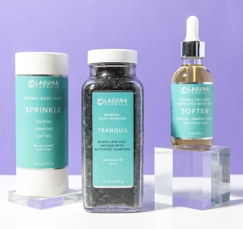 Charcoal bath set with three steps - a black lava charcoal bath salt, a talc-free body dust, and a body oil.