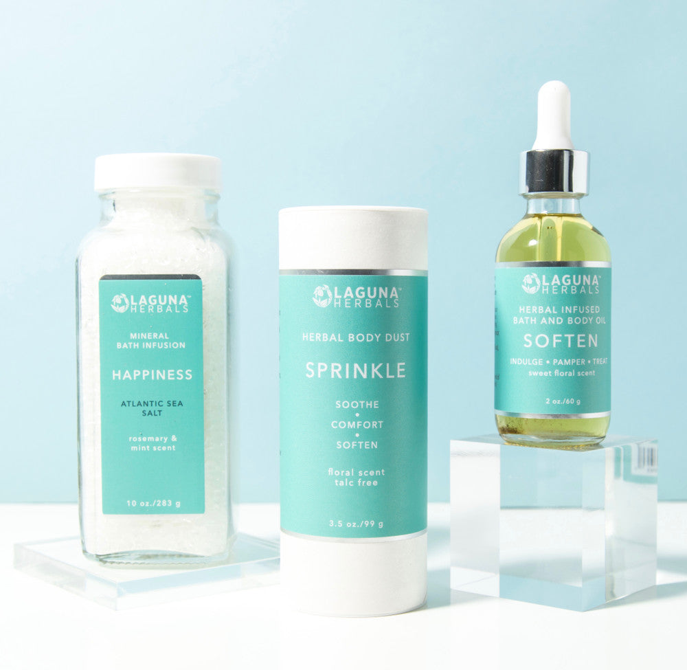 Happiness Is bath and body set with three steps - a mineral bath soak, a talc-free body powder, and a herb-infused body oil.