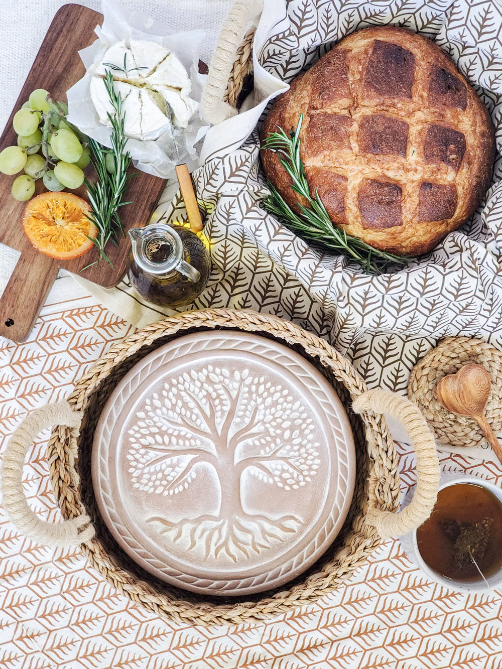 Tree of Life bread warmer set styled with a cloth-lined basket