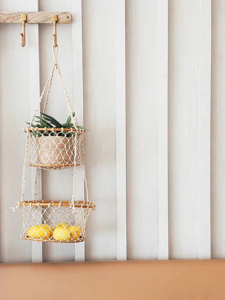 Double hanging basket made of natural jute with metal hooks, suitable for indoor or outdoor plant displays.