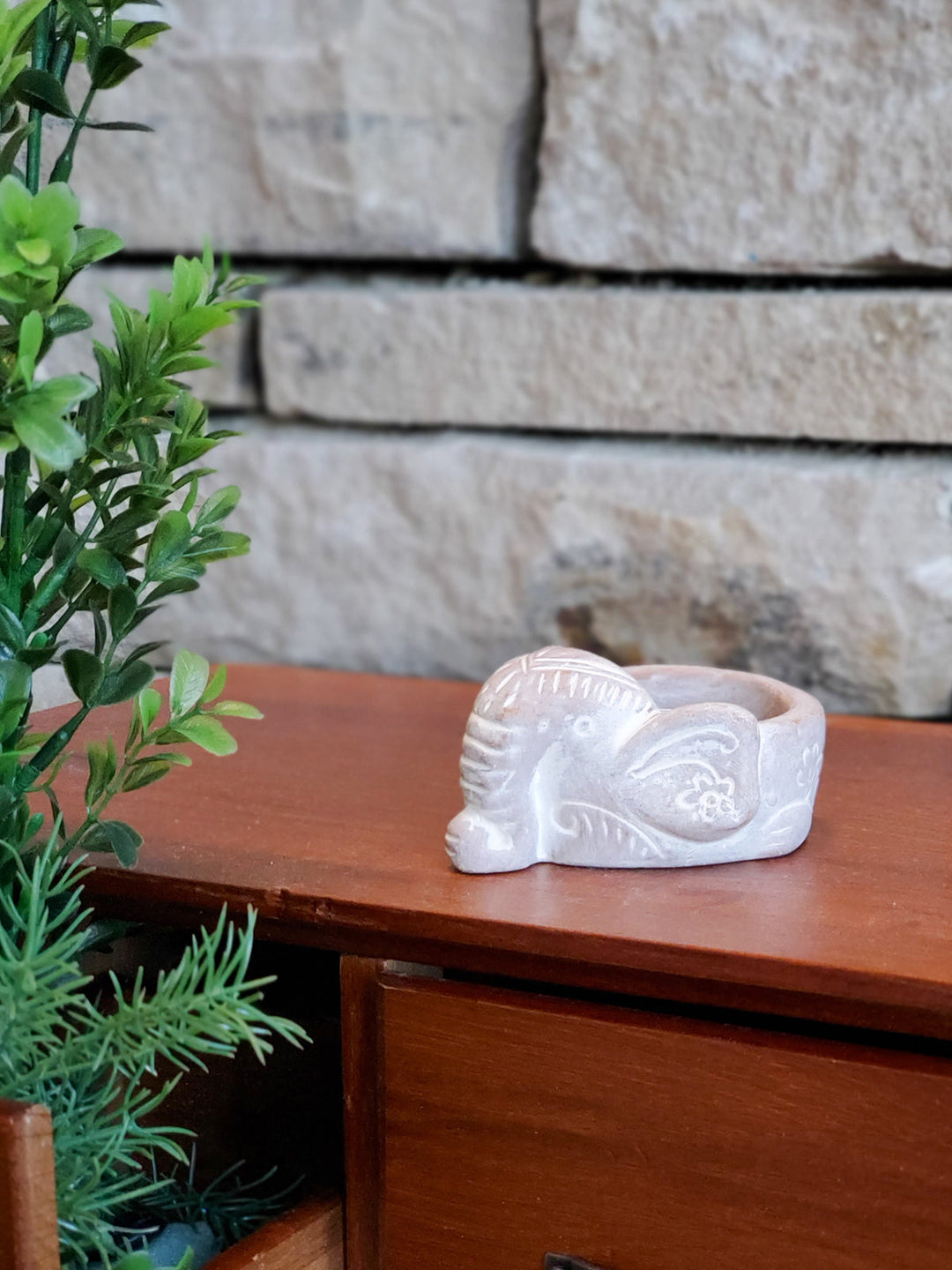 Elephant terracotta candle holder styled with a lit tea light