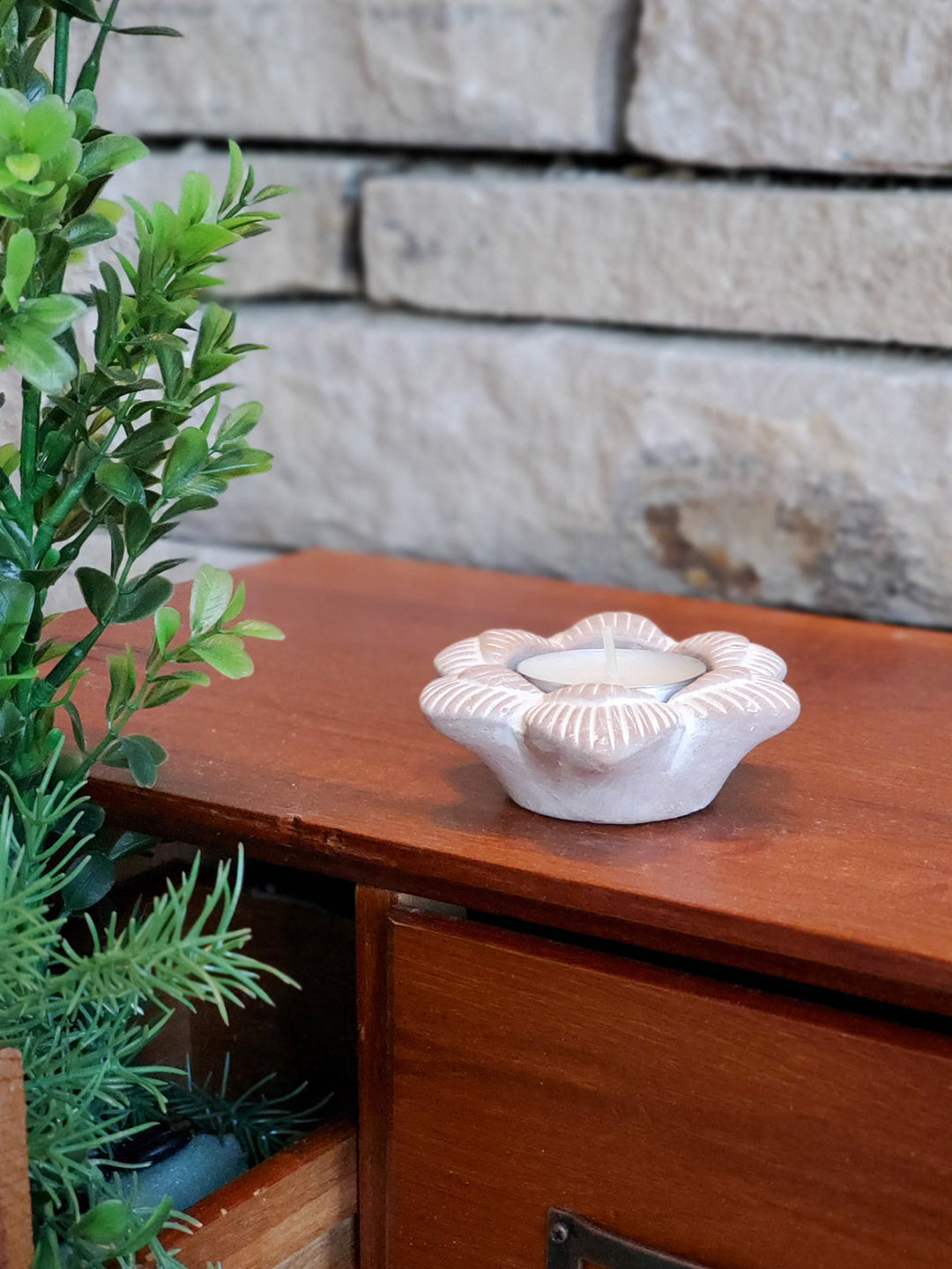 Flower terracotta candle holder in a natural clay finish