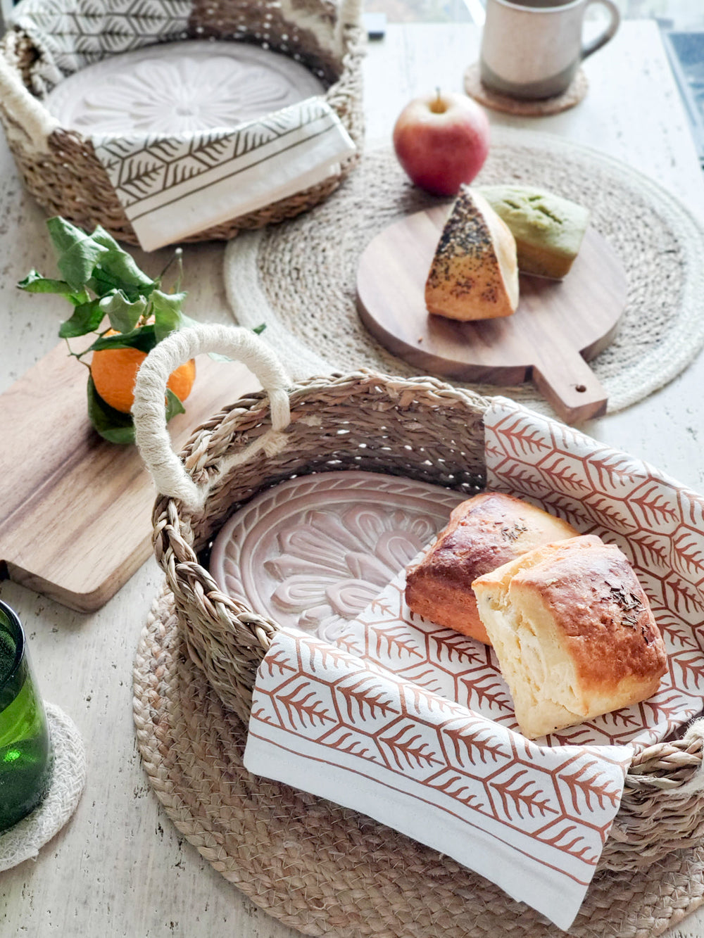 Flower bread warmer basket styled with fresh bread on a table