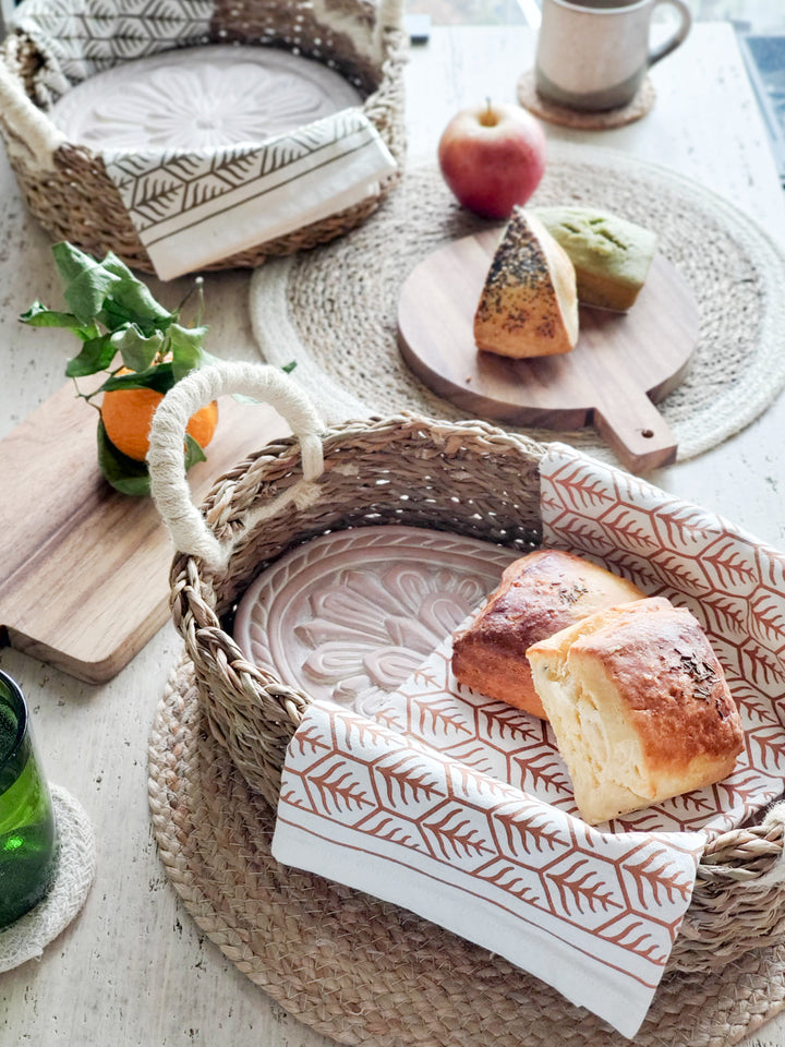 Flower bread warmer basket styled with fresh bread on a table